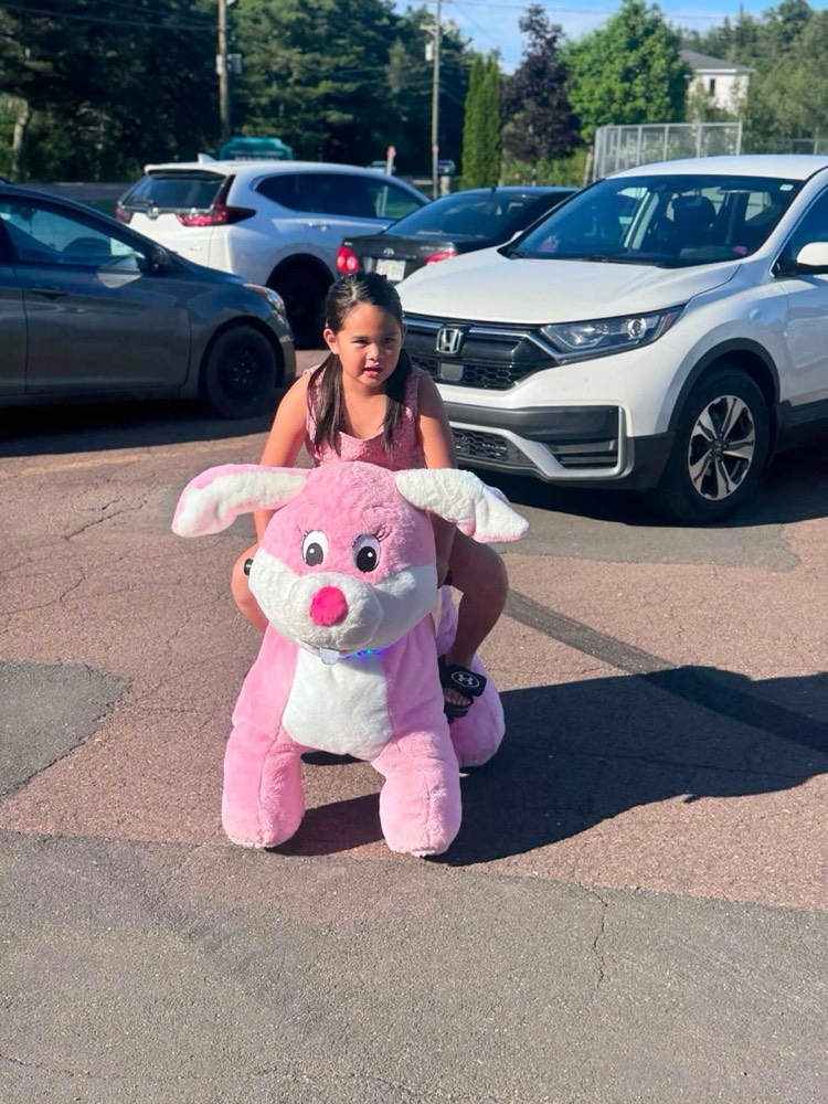 Child riding a pink ride-on