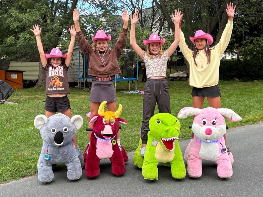 Group cheering with the ride-on animals outdoors